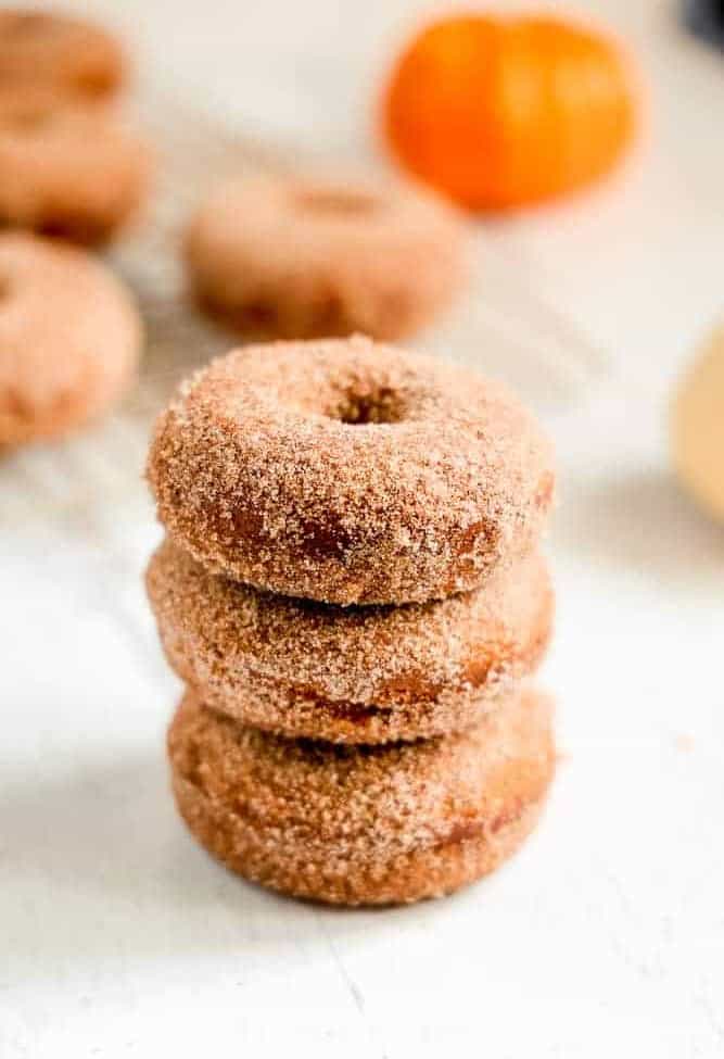 three pumpkin donuts stacked on each other