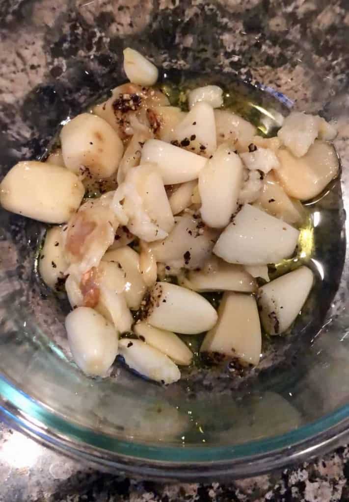 glass bowl with roasted garlic cloves inside