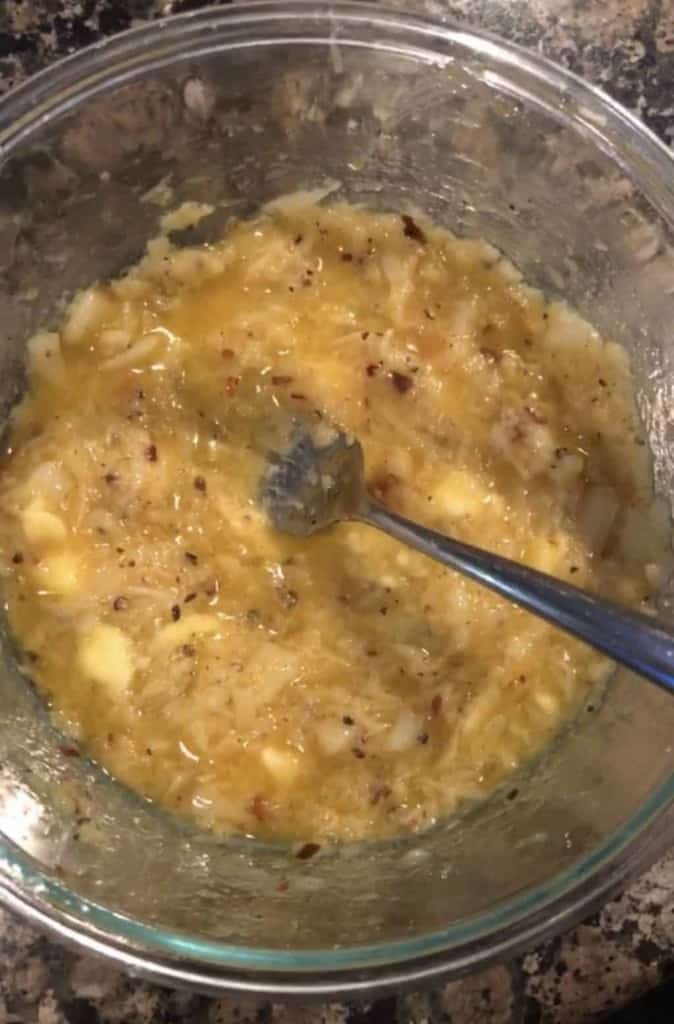 mashed roasted garlic with butter and red pepper flakes in a bowl