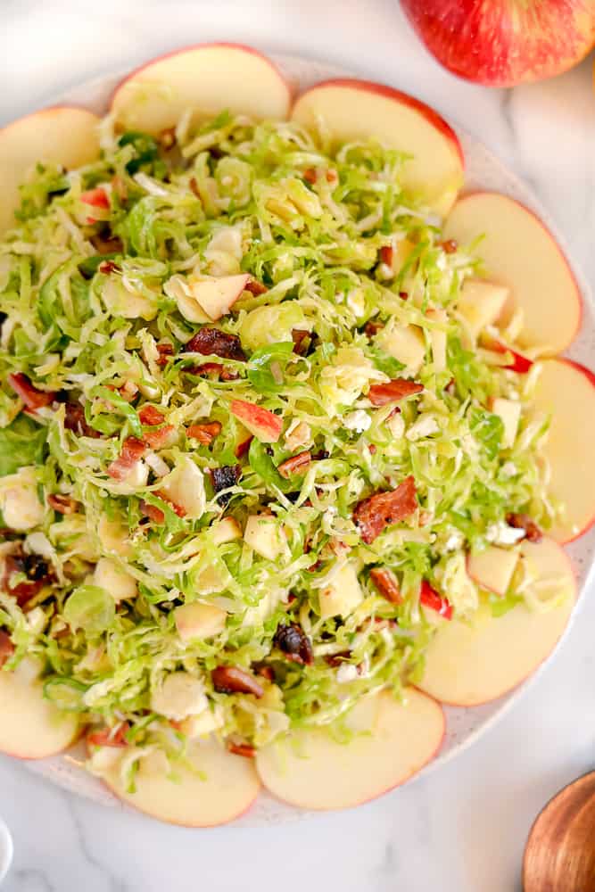 overhead photo of shaved brussels sprouts surrounded by sliced apples