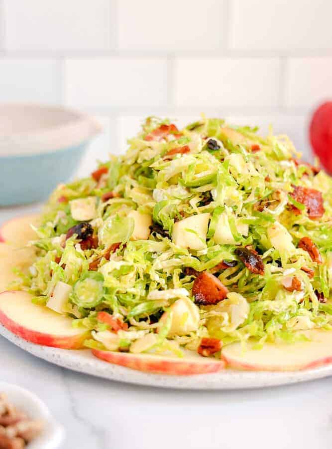 close up of shaved brussels sprouts surrounded by apples