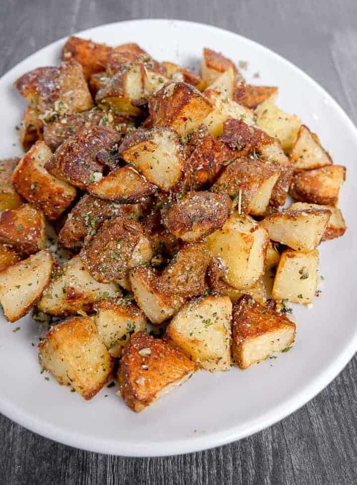 crispy roasted square potatoes on a white plate