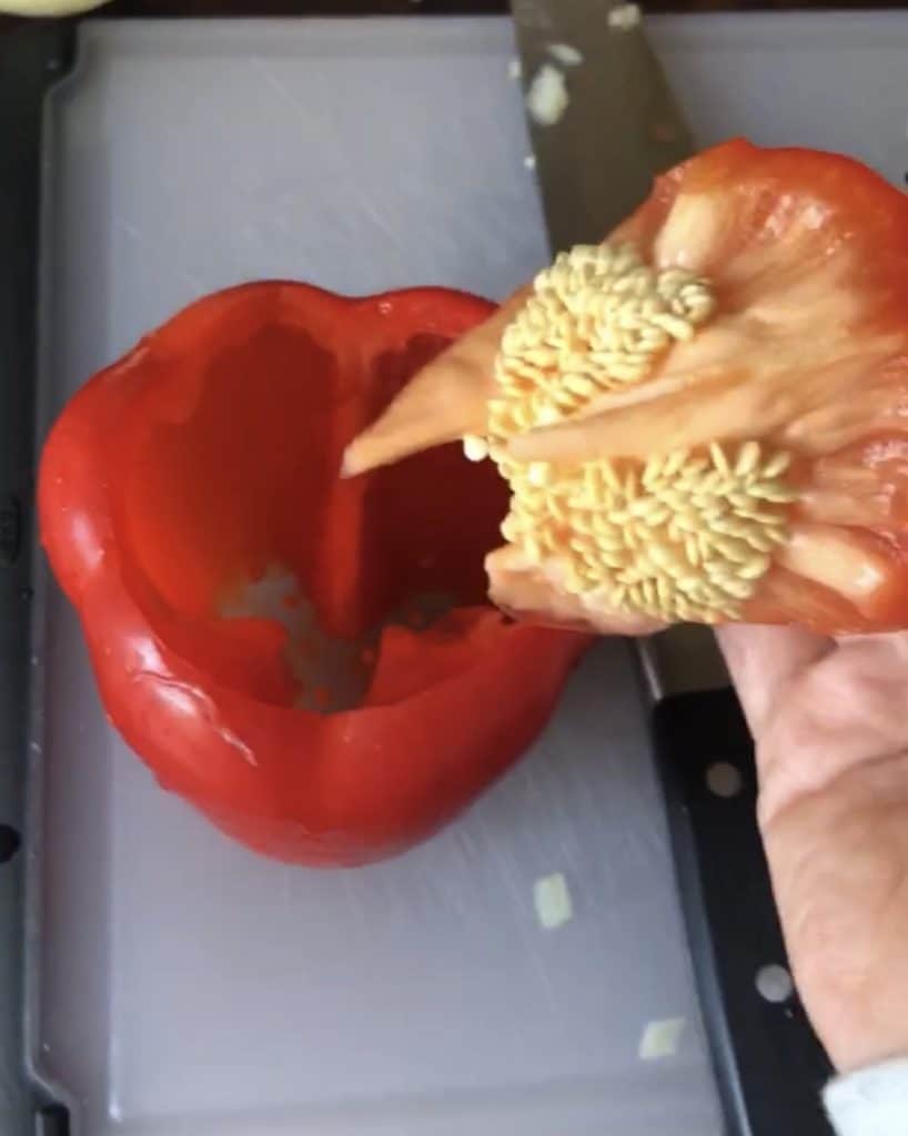 bell pepper on a cutting board with stem and seeds removed