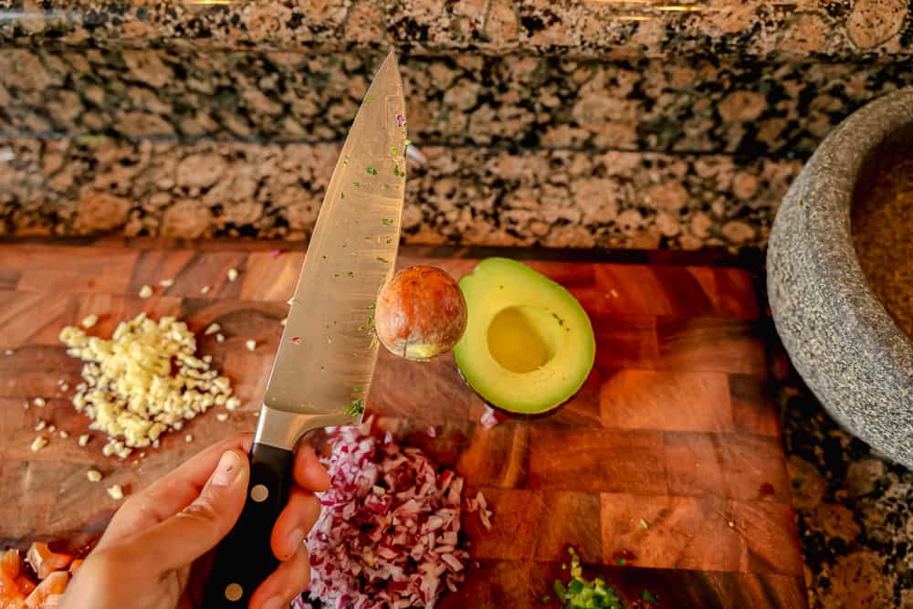 avocado pit on a knife