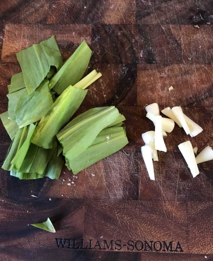 chopped up ramps on a wooden cutting board