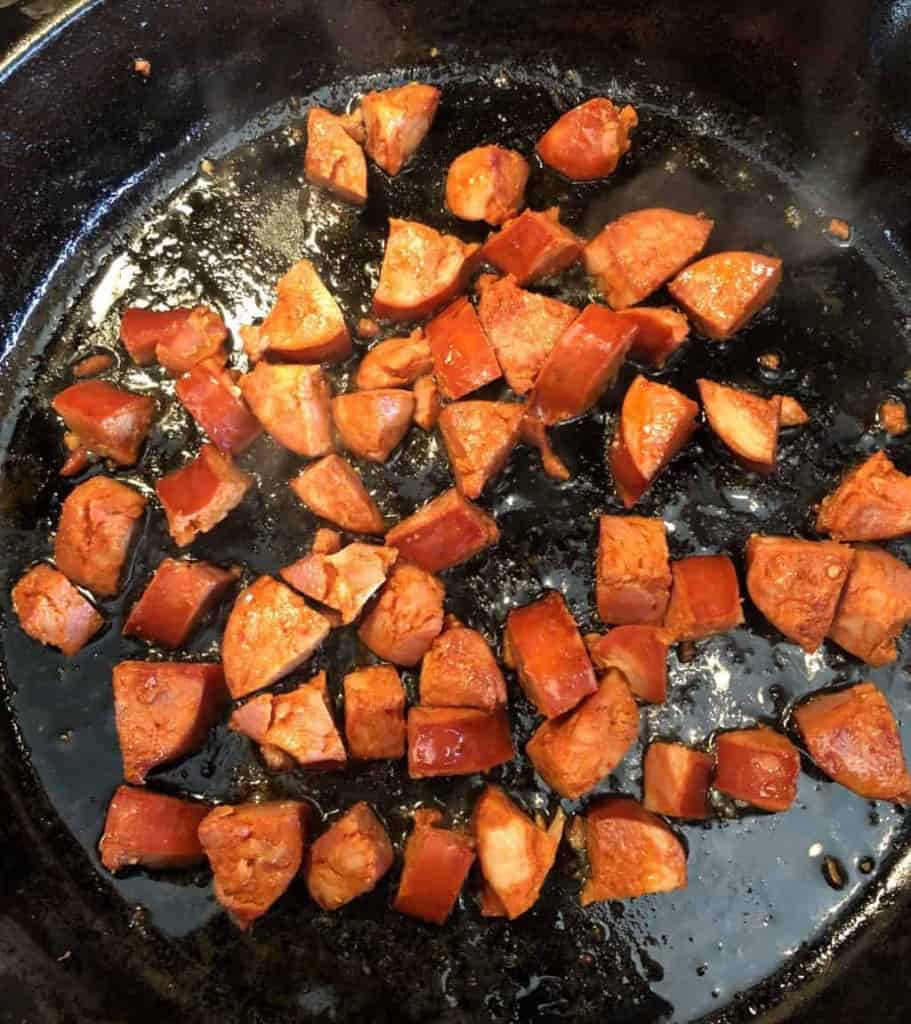 diced chorizo in a cast iron skillet cooking