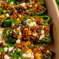 zoomed in stuffed poblano pepper with ground beef, beans, and corn