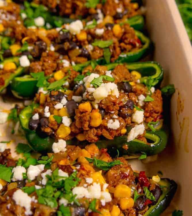 zoomed in stuffed poblano pepper with ground beef, beans, and corn