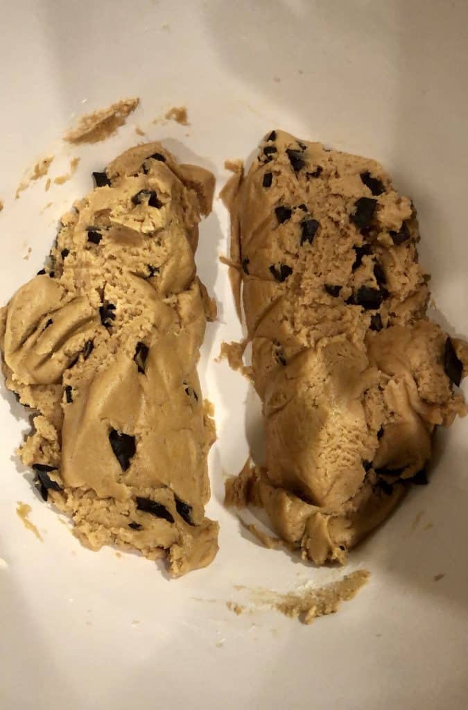 divided cookie dough with chocolate chips in a white bowl