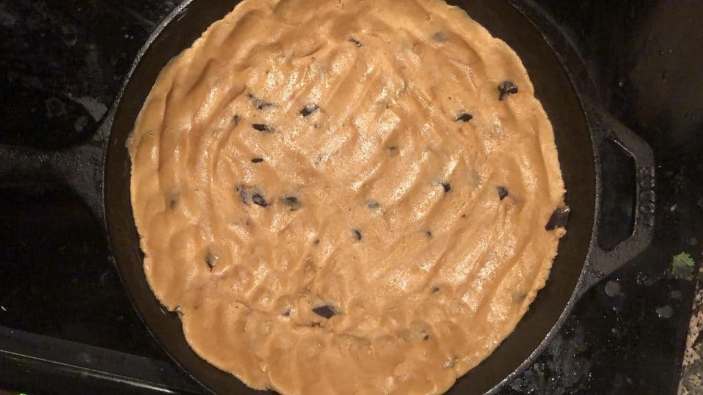 raw cookie dough in a cast iron skillet