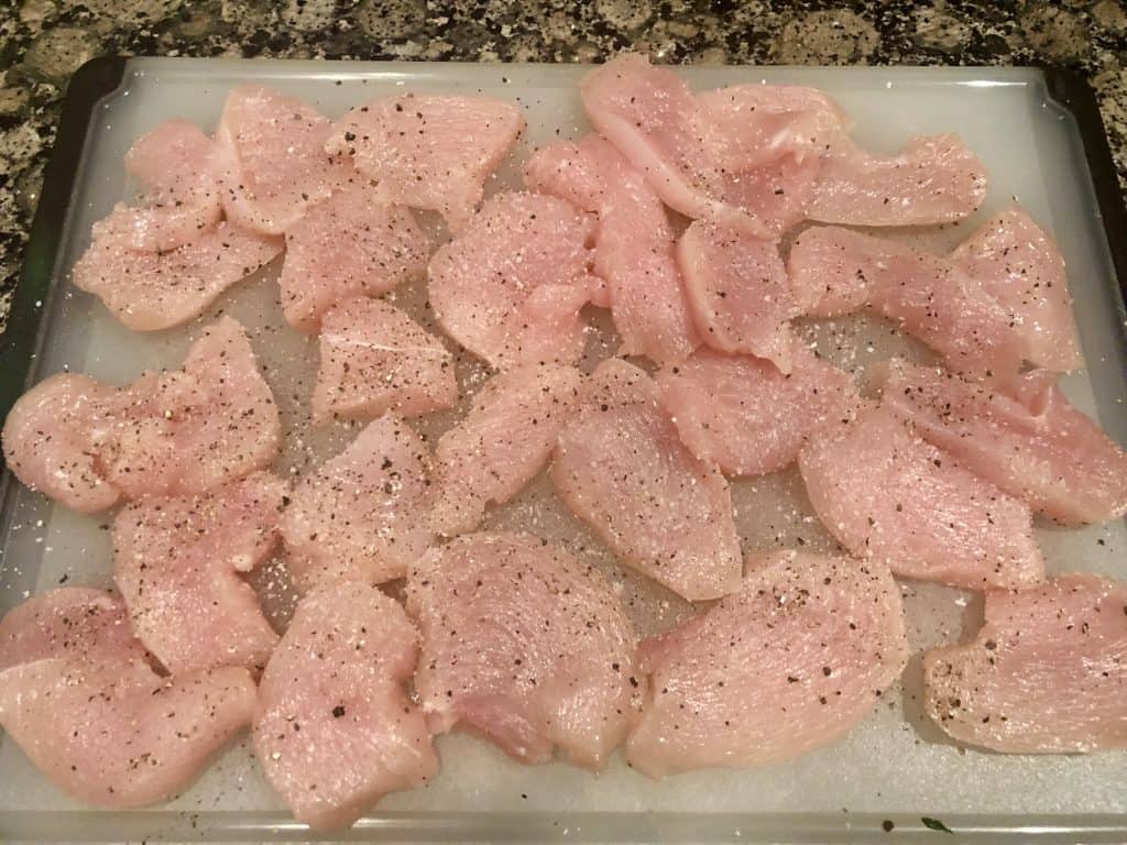 sliced 1 inch pieces of chicken breast with salt and black pepper
