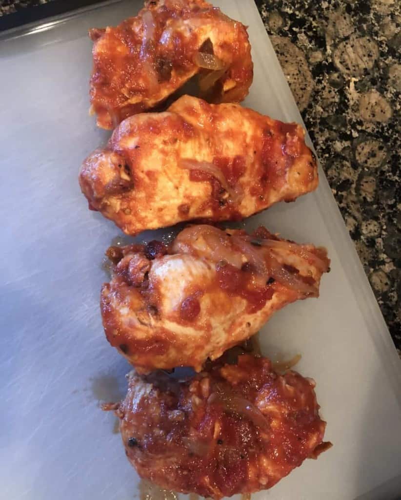 chicken breasts post slow cooking on a cutting board