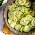 close up of cucumber salad in a wooden bowl