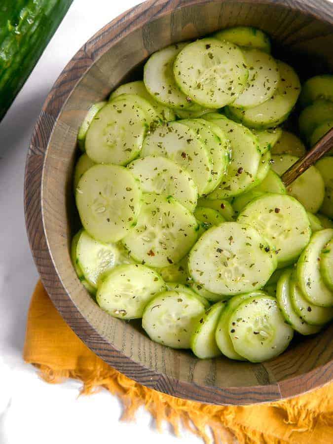 close up of cucumber salad in a wooden bowl