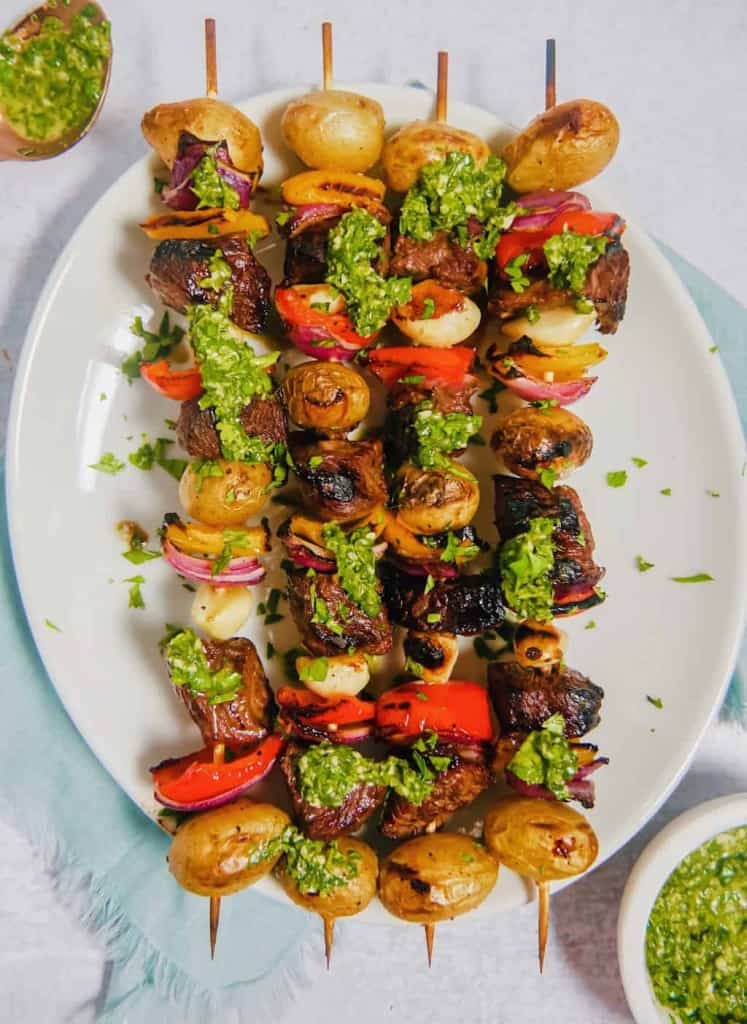 Marinated beef kabobs on a white plate 