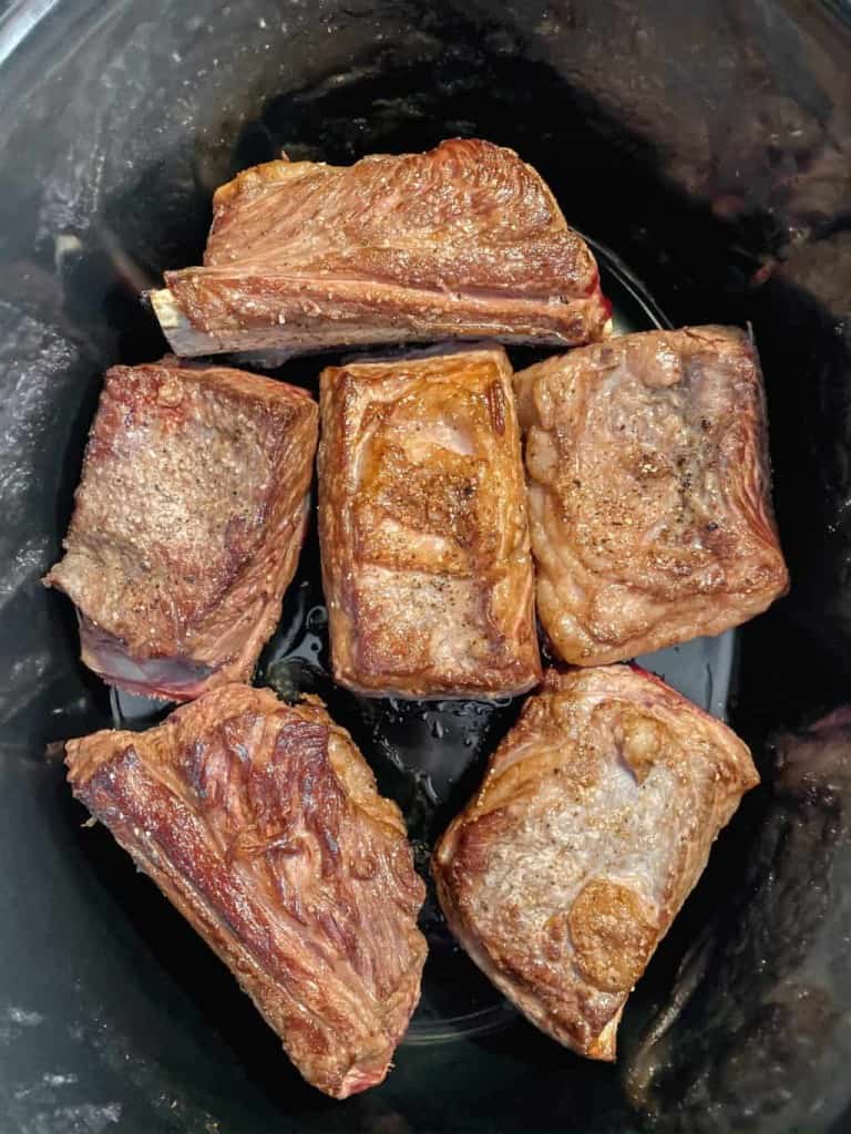 Seared beef short ribs in a slow cooker