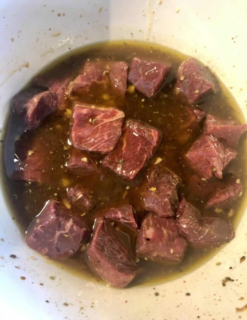 cubed sirloin steak in a bowl with steak marinade