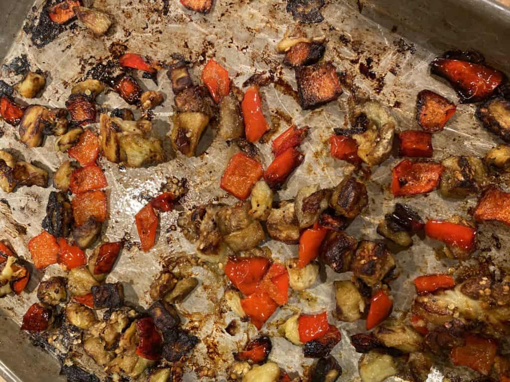roasted eggplant and bell pepper on a baking sheet