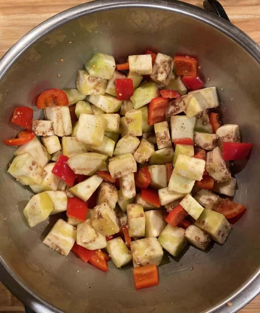 diced eggplant and bell peppers in a metal bowl