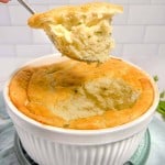soufflé dish with mashed potato soufflé being lifted out with a spoon