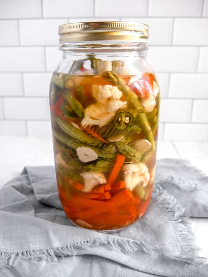 photo of pickled vegetable jar on blue napkin