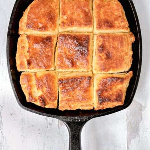 overhead photo of biscuits in a cast iron skillet