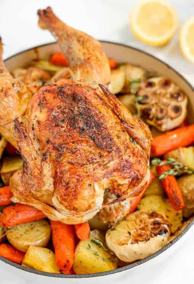 whole roasted chicken on bed of vegetables