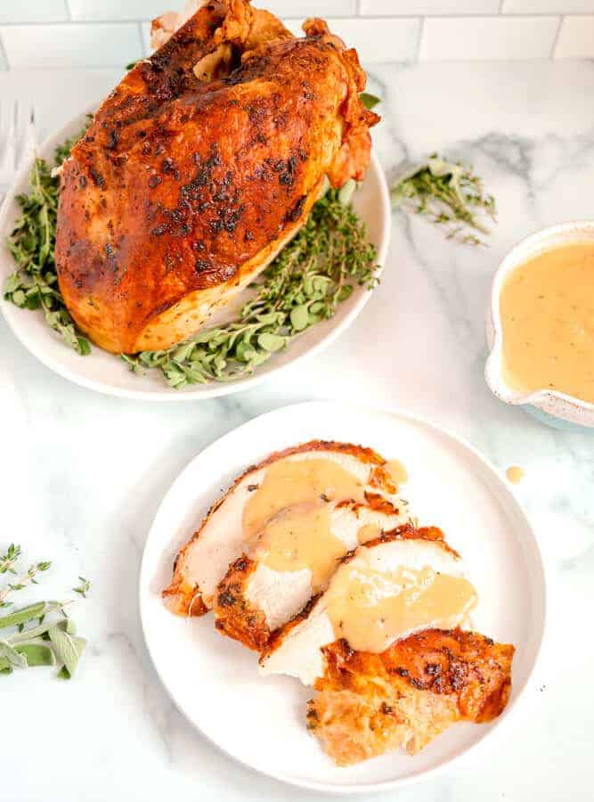 roasted turkey breast with sliced turkey and gravy over the top
