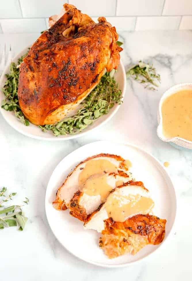 roasted turkey breast with sliced turkey and gravy over the top