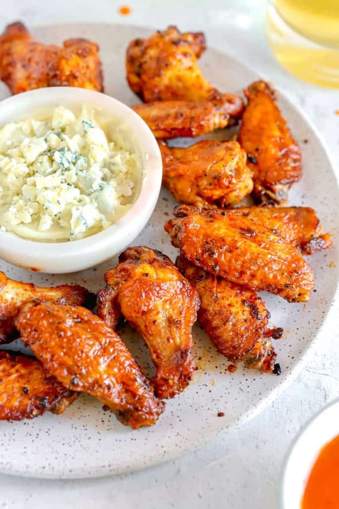 chicken wings on a plate with blue cheese dip