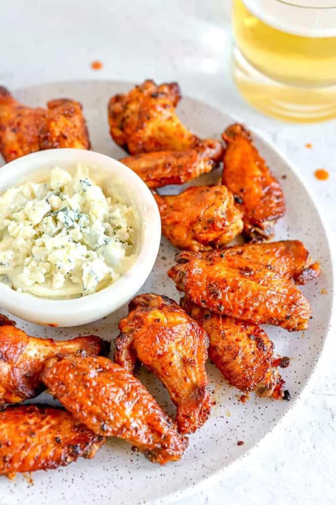 chicken wings on a plate with blue cheese dip