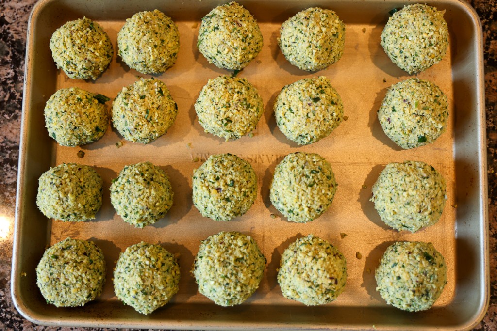 pre-cooked falafel balls on a baking sheet