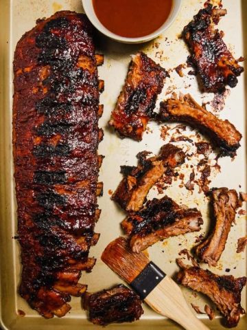 These baby back ribs are seasoned with a homemade dry rub and then baked in the oven till they are tender and fall off the bone. Slather these ribs with your favorite BBQ sauce and finish them on the grill for juicy, tender, fall off the bone ribs.