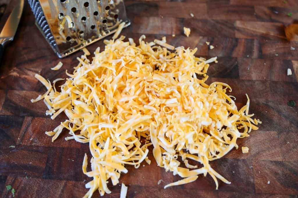 grated colby jack cheese on a cutting board