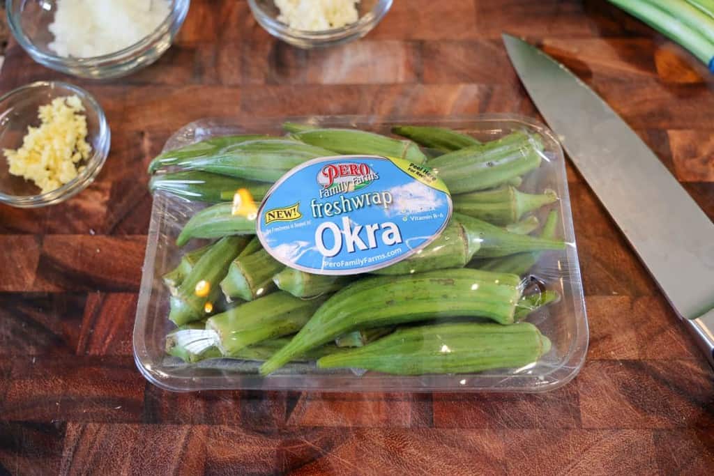 packet of fresh okra on a cutting board