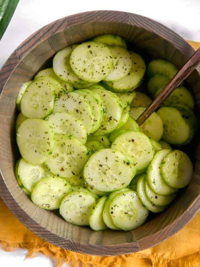 Easy cold cucumber salad with thinly sliced cucumbers marinated in a herb vinaigrette