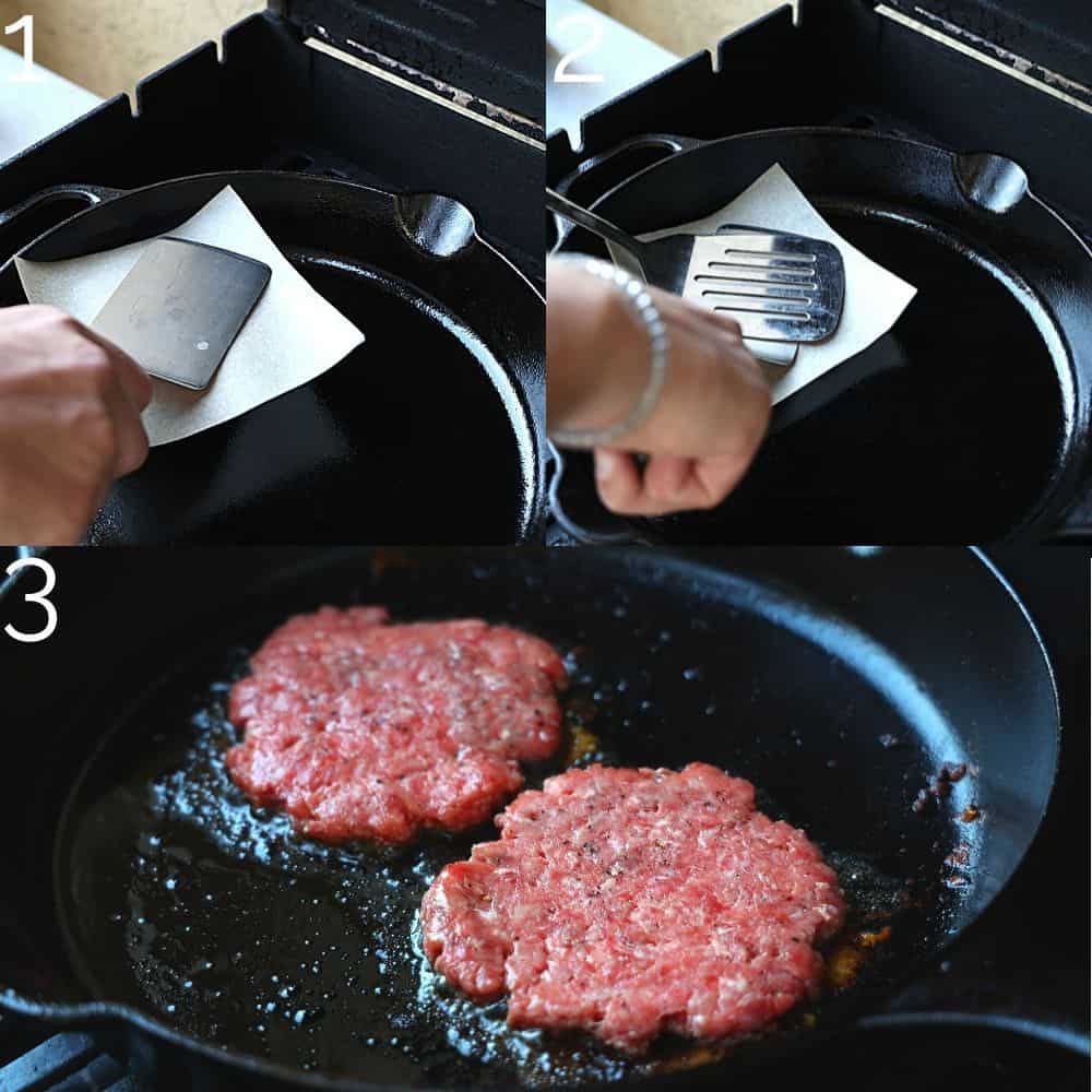 smashing burger pattys thin with a spatula and parchment paper on cast iron skillet
