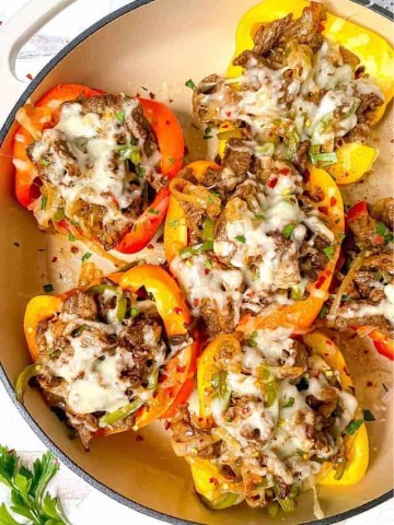 cheesesteak stuffed bell peppers with melted cheese on top