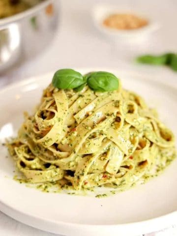 mound of creamy pesto pasta on a white plate