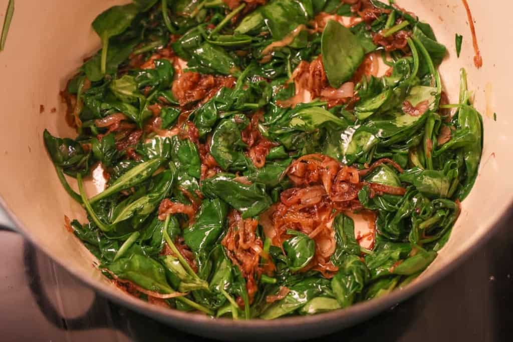 sauteéd spinach and caramelized onions in a dutch oven