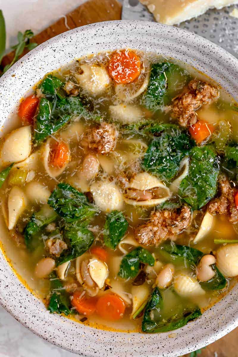 soup bowl with white beans, hot italian sausage, spinach, and carrots