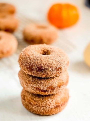 pumpkin spice donuts stacked on eachother