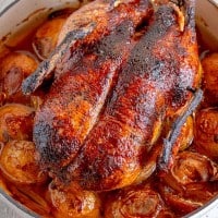 soy ginger glazed whole duck over a bed of roasted duck fat potatoes