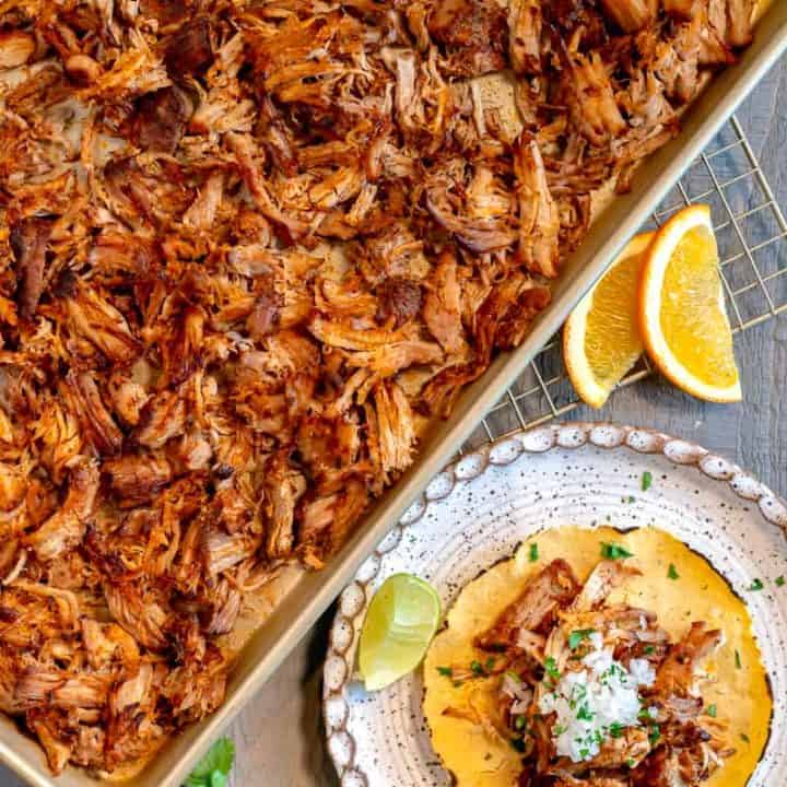crispy shredded pork on a pan with a charred tortilla and minced onion on top