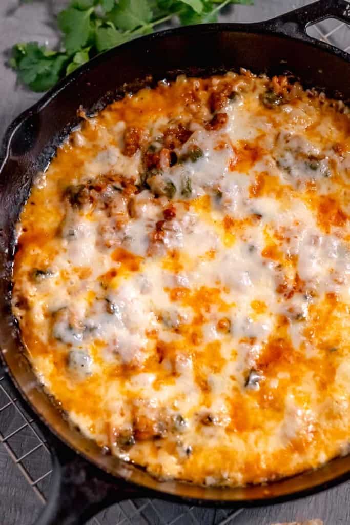 melted queso fundido in a cast iron skillet