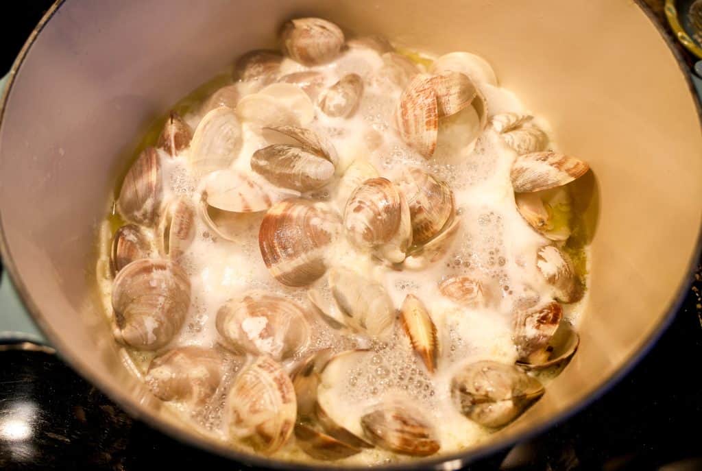 clams steaming open in a pot