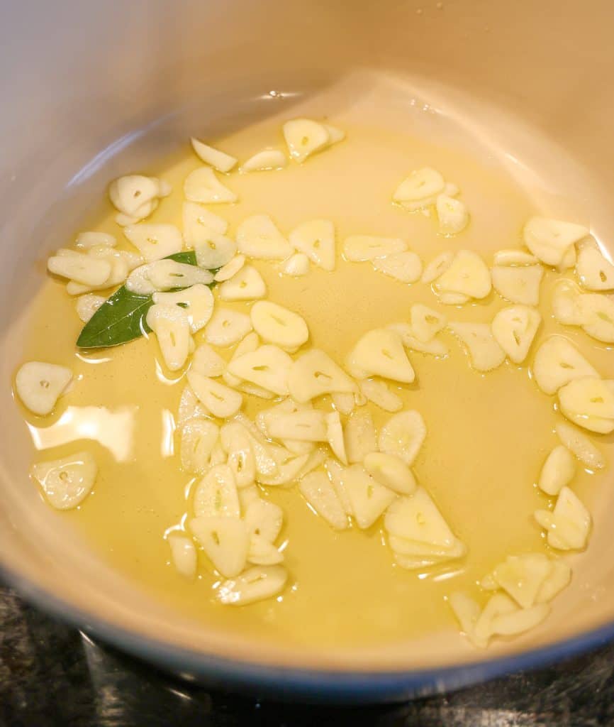 sautéing garlic and bay leaf in olive oil in a dutch oven