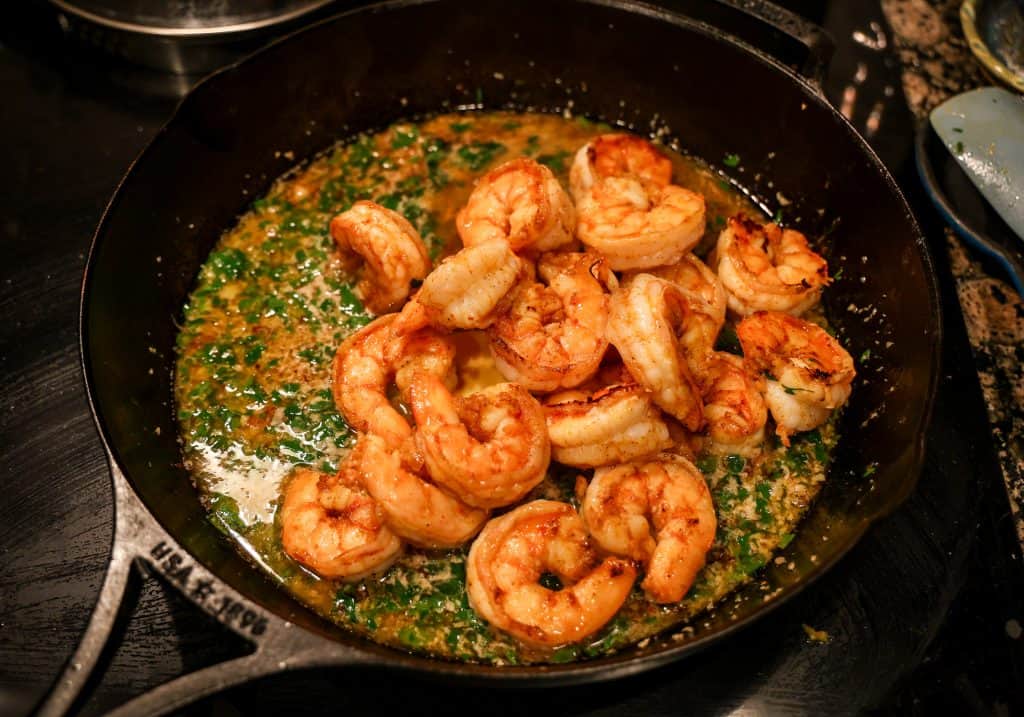 shrimp in a cast iron skillet with garlic and parsley