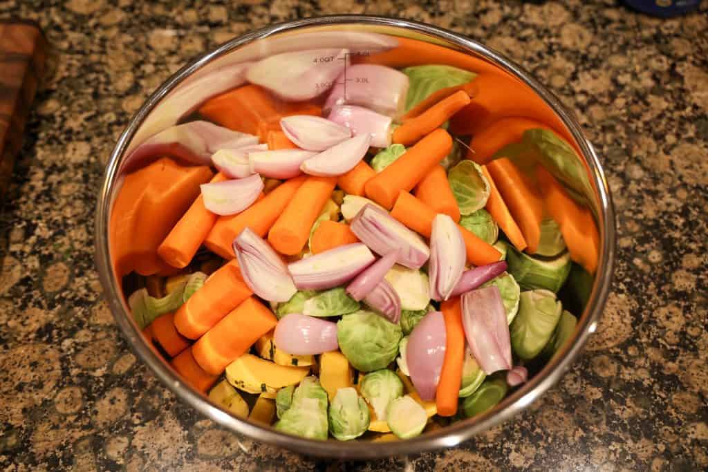metal bowl with carrots, broccoli, shallots, and squash slices