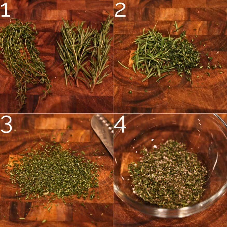 chopping fresh thyme and rosemary leaves on a wooden cutting board